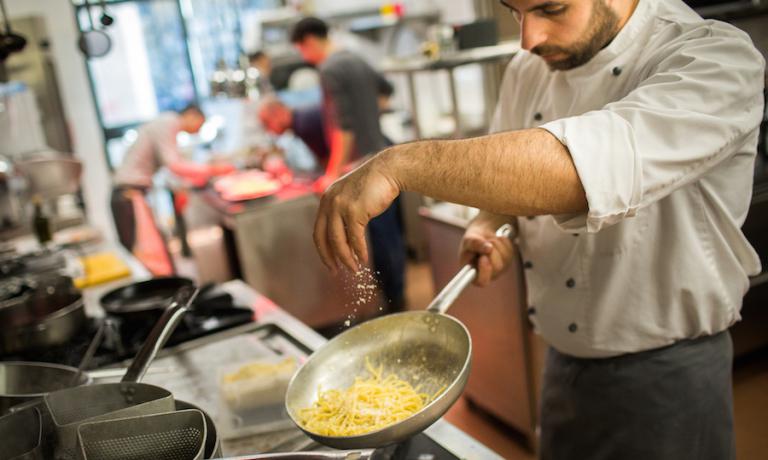 A cook at work in Marta in cucina’s kitchen in Reggio Emilia. Photo by Niccolò Cozzi